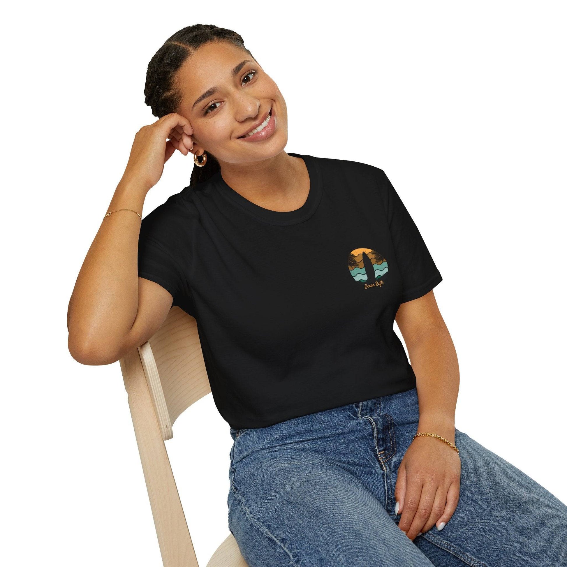 women leaning over and posing with black regular fit leightweight shirt for men and women with surfboard palm trees and beach graphics back and front with surfing and camping and ocean rafts text $40 free delivery cheap | Ocean Rafts