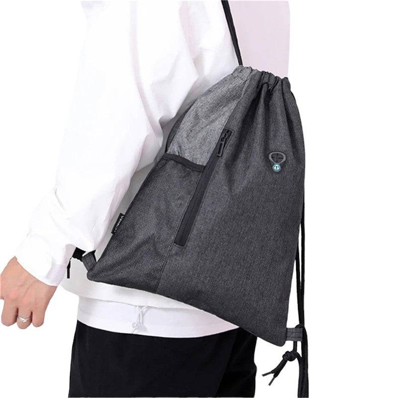 man wearing nylon dawstring bag with water bottle net pocket and 2 zips with extra pouch and pocket free delivery $20 | Ocean Raft